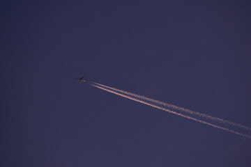 jet plane for passengers on the blue sky. domestic transport aircraft polluting with smoke in the blue sky