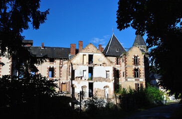 View of Derelict 19th Century Hotel against Blue Sky 