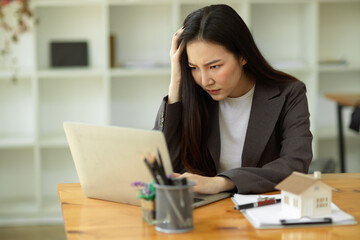 Pensive, Thoughtful, Serious, Ponder young asian businesswoman working on her laptop
