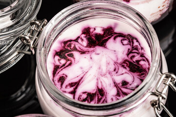 Blueberry nights cheese cake in a personal jar on black background