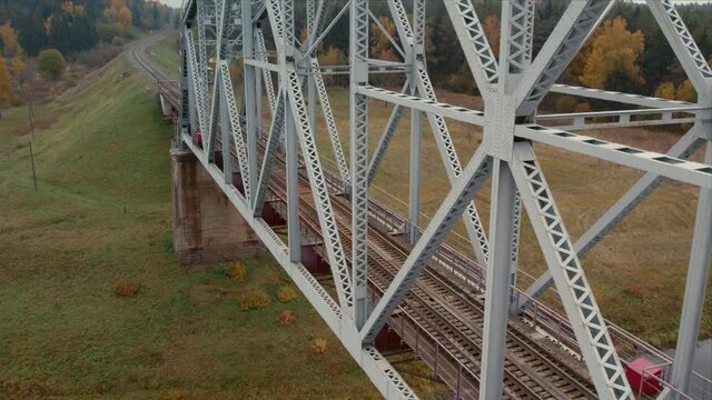 Metal railway train arc bridge over the river Belarus Orsha Dnieper River. rusty rails, autumn Aerial top down footage from drone