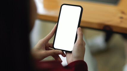 Close-up of a woman using a modern smartphone to research business trends