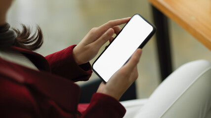 Businesswoman uses smartphone to trade stocks, check business income, and contact business partners.