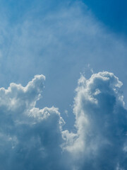 Cloud fingers reaching for something. Or clouds flipping the bird, showing the middle finger.