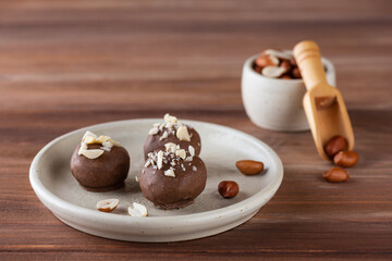 Homemade truffles with peanuts in milk chocolate. Sugar, gluten and lactose free, vegan.