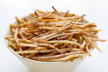 Fried taro sticks on white background.