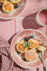 cheesecakes with powdered sugar on a pink background