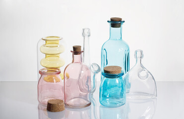 colored glass bottles on white background