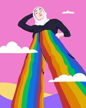 Woman standing in hijab wearing LGBTQ+ rainbow trousers