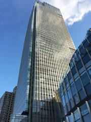 Tall building seen against a blue sky in Tokyo, Japan.