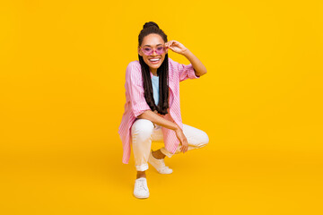Full body photo of happy dark skin positive woman wear sunglass summer smile isolated on yellow color background © deagreez