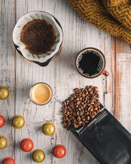 Coffee beans, coffee capsules, espresso and filter coffee (V60) on table