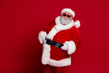 Portrait of attractive cheerful Santa posing big belly newyear festal day time look isolated over bright red color background