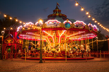Fototapeta na wymiar Carousel in the night autumn park.