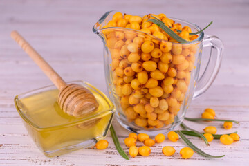 Fresh sea buckthorn berries and honey.
Close-up.