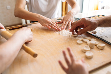 family traditions, Family together at the table make dumplings