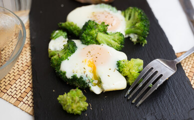 breakfast of crumpled eggs with broccoli