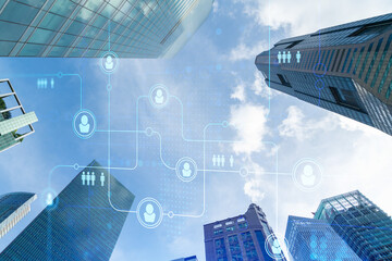 Social media icons hologram over low angle shot of Singapore skyscrapers, Southeast Asia. The concept of people networking, connections and career opportunities. Double exposure.