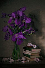 Still life with purple irises in a vase and shells lying nearby © Анна Ременюк