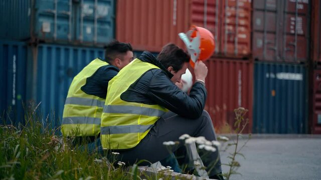 Industrial Worker Works With Co-worker At Overseas Shipping Container Yard . Logistics Supply Chain Management And International Goods Export Concept. End Of The Work Day