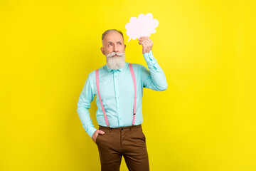Photo of strict mature man hold bubble wear blue shirt isolated on vibrant yellow color background
