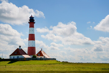 Fototapeta na wymiar Lighthouse Westerhever in Schleswig Holstein, Germany. View on landscape by national park Wattermeer in Nordfriesland.