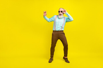 Full length body size photo elder man in sunglass dancing at party chilling isolated bright yellow color background