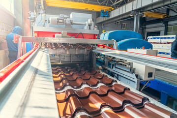Production line of metal tile for roof. Conveyor belt at metalworking manufacturing plant.