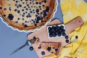 Blueberry tart on a table. Close up photo of freshly baked pie with honey and blueberries, no sugar added. Healthy eating concept. 