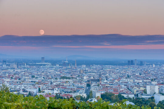 HDR image of Vienna with the moon almost full over the city