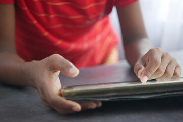 child hand pointing finger on digital tablet screen.