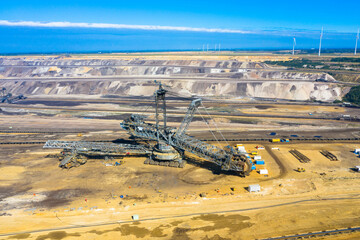 A huge bucket-wheel excavator digging coal on the open-pit mine. Garzweiler open cast mine,...