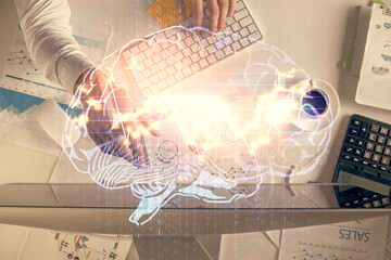 Double exposure of man's hands typing over computer keyboard and brain hologram drawing. Top view. Ai and data technology concept.