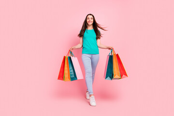 Full body photo of young woman happy positive smile go walk black friday shopaholic isolated over pastel color background