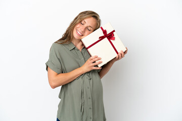 Fototapeta premium Young caucasian woman isolated on white background pregnant and holding a gift