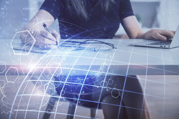 Double exposure of woman hands working on computer and world map hologram drawing. International technology business concept.