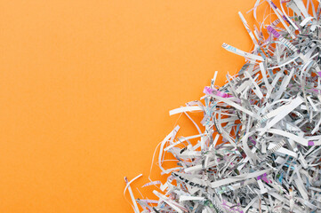 The shredded paper on light orange background.