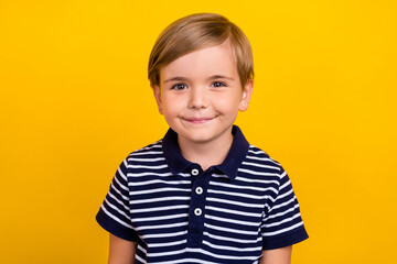 Photo portrait little boy wearing striped t-shirt smiling isolated bright yellow color background