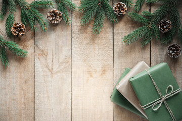 Christmas zero waste background with gift boxes, fir tree branches and pine cones