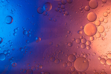 Water in oil in abstract style on blue background. blue liquid splash. Golden yellow bubble oil abstract background.