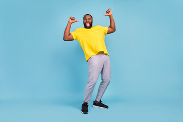 Fototapeta na wymiar Photo of sweet excited dark skin guy dressed yellow t-shirt smiling pointing fingers himself isolated blue color background