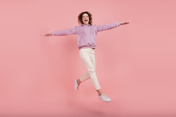 Fototapeta na wymiar Full body photo of mature woman carefree happy positive smile jump wings fly isolated pink color background