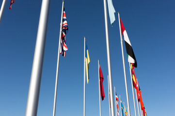 World flags display on a clear and calm day, with flags hanging downwards due to no wind