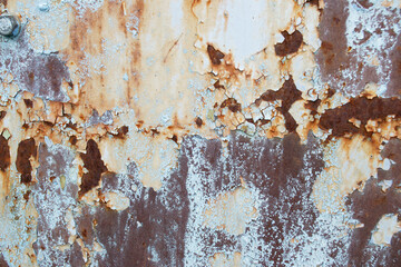 Rusty metal background. Rotten steel, scratched and cracked metal texture. Blurred focus of the rusty texture