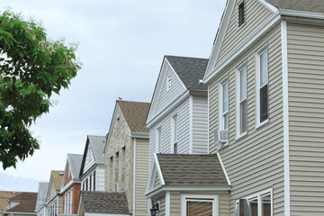  A row of tract houses on a residential street.