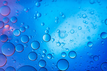 Water in oil in abstract style on blue background. blue liquid splash. Golden yellow bubble oil abstract background.