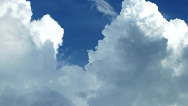 Stunning huge cumulus clouds swirl in the daytime. Timelapse, relaxation weather dramatic beauty atmosphere background