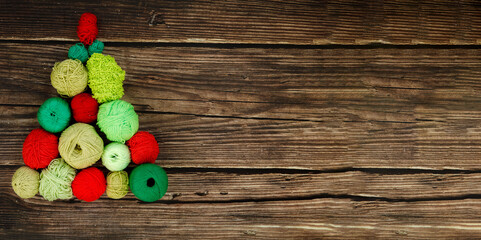 Merry Christmas and Happy New Year. Funny creative Christmas tree made green and red woolen balls...