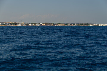 View of the Mediterranean coast with dip blue water and the city on the coast. Cyprus. Rest at the sea. Cruise