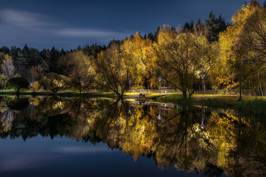 Moscow. October 15, 2021. Golden autumn in Meshchersky park.  Beautiful night landscape with reflektion in the pond.